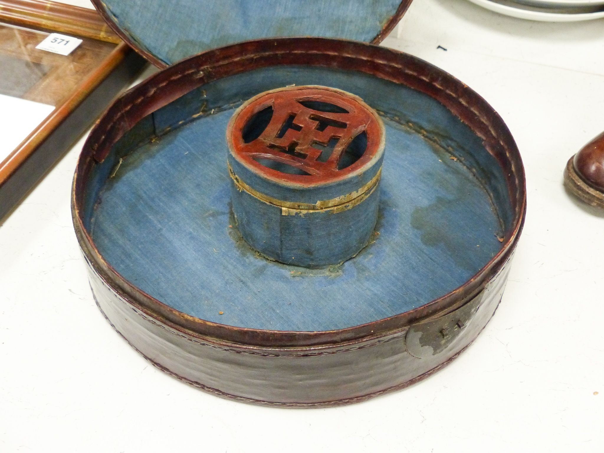 A Chinese late Qing mandarin hat, with gilt finial and original hide case